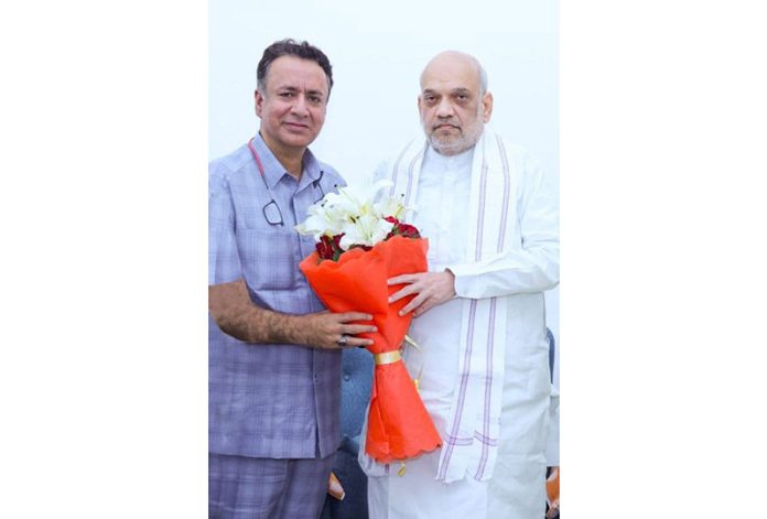 Former Minister and Apni Party vice president, Chowdhary Zulfkar Ali presenting a bouquet to Union Home Minister Amit Shah at New Delhi on Saturday.