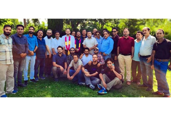 Gulzar Ahmed Zargar, newly elected president of BWJA posing along with other members of the association in Baramulla on Monday.