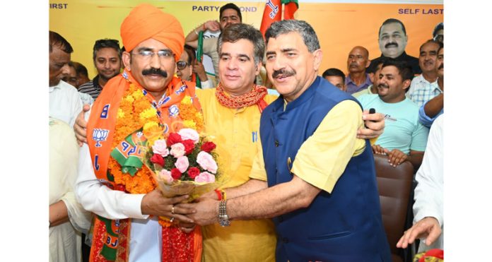 BJP leaders welcoming former SSP Mohan Lal Bhagat who joined the party at Jammu on Saturday.