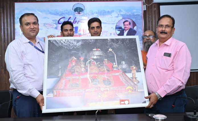 CUJ Registrar and others presenting a Mata Vaishno Devi photo frame to VC during Foundation Day function of the university.