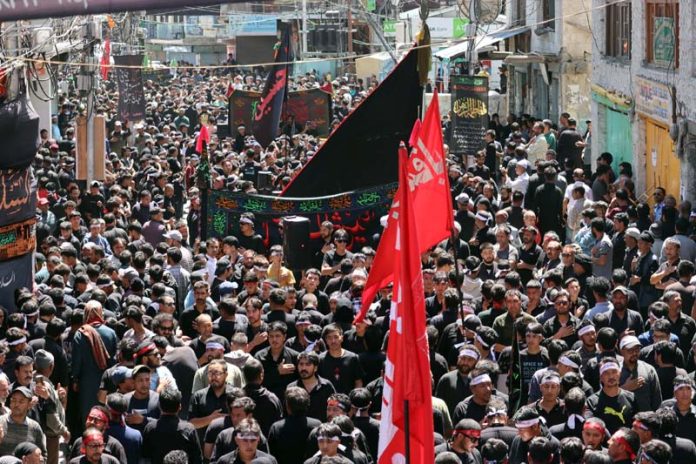 A large number of mourners participating in procession taken out by JUIAK in Kargil on Monday.