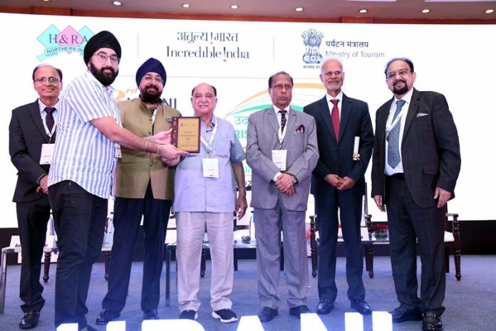 An Asia Greens, Jammu representative receiving an award from HRANI leaders in Greater Noida.