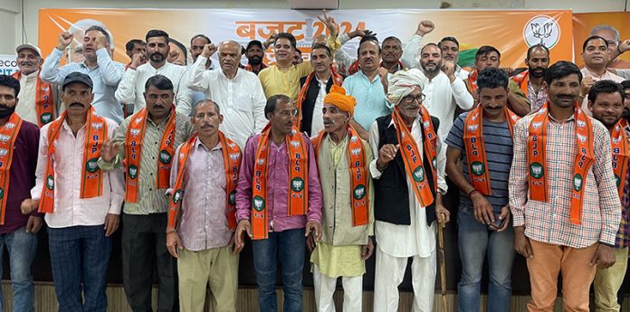 Activists of various political parties who joined BJP posing with senior party leaders at Jammu on Friday.