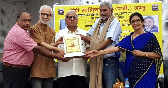 Dr. Rattan Lal Shant along with others presenting an award to Rakesh Abrol in Jammu on Saturday.