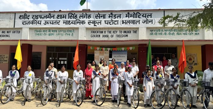 Girl students of GHSS Gharota posing with the bicycles provided to them by FICCI FLO JKL.