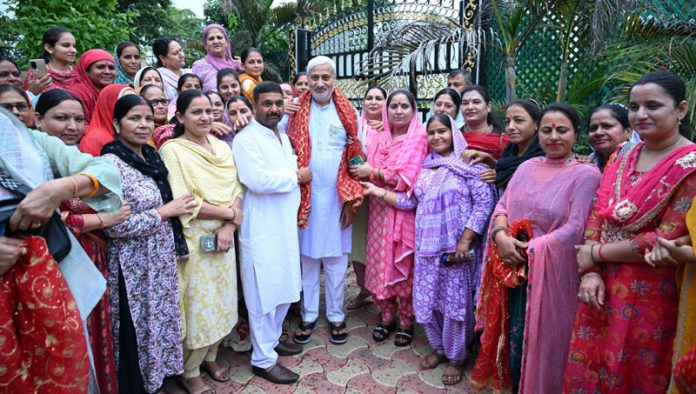 BJP leader Sham Lal Sharma who is candidate from Jammu West, being welcomed by women activists on Friday.