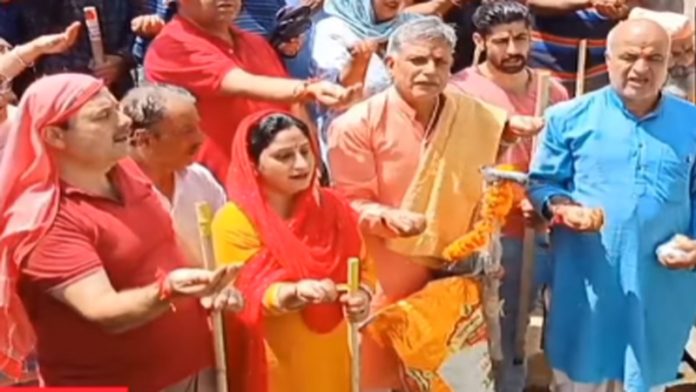 Devotees performing Puja at Navdal Tirath Tral before immersion of relics in the spring.