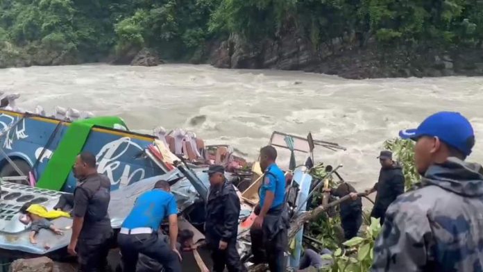 Rescuers work at the accident site on the bank of the Marsyangdi river in Tanahun district of Nepal.