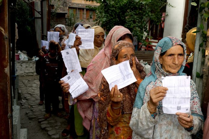 Women voters outside a Polling Station in Srinagar on Wednesday. -Excelsior/Shakeel