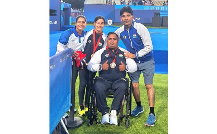 Archers Sheetal Devi and Rakesh Kumar posing along with their coaches at Paris.