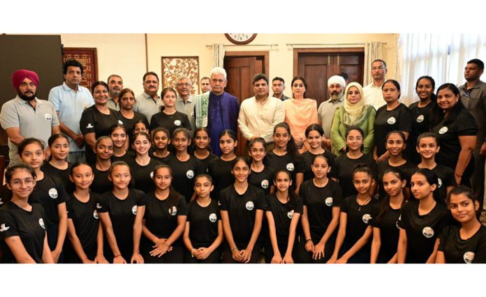 Lieutenant Governor Manoj Sinha posing along with officials, coaches and Gymnasts at Raj Bhawan in Srinagar.