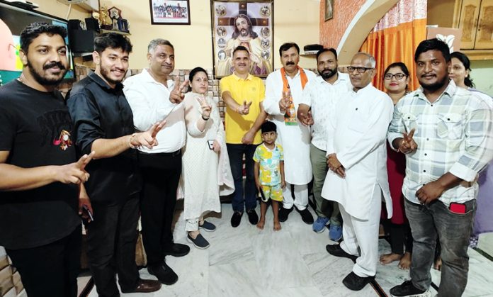 BJP contesting candidate from the Jammu West, Arvind Mahajan posing with people of Valmiki community at Bakshi Nagar, Jammu.