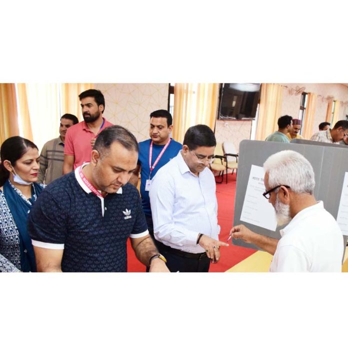 DEO Kishtwar Rajesh Kumar Shavan alongwith others casting votes on Saturday.