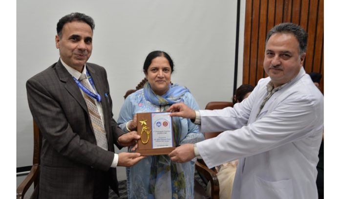 Prof Shiv Kumar Sarin (president NAMS) honouring a Principal during inaugural Principal's Conclave at SKIMS in Srinagar.