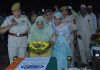 Kin of martyred HC Bashir Ahmed laying wreath on his mortal remains during wreath laying ceremony organized by J&K Police at Gulshan Ground, Jammu. —Excelsior/Rakesh