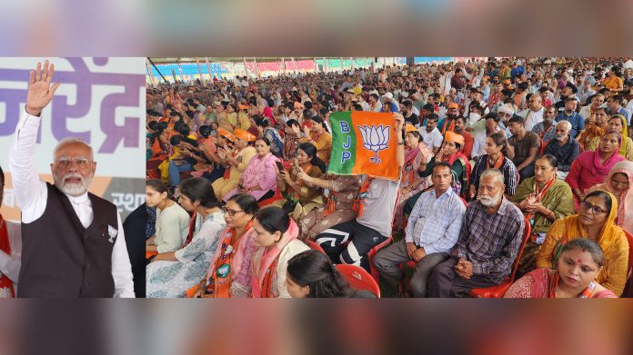 PM Narendra Modi waving to people during rally at MA Stadium in Jammu on Saturday. - Excelsior/Rakesh