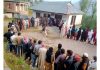 People stand in a queue to cast votes at Surankote.