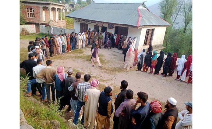 People stand in a queue to cast votes at Surankote.