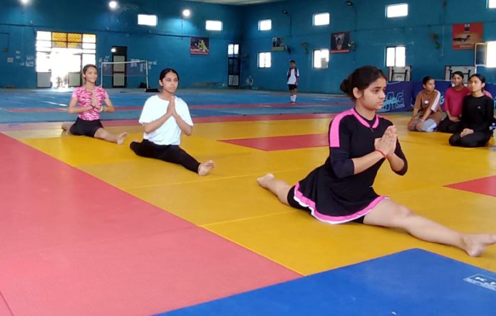 Athletes performing Yoga during District Level Inter-School Tournament at Udhampur.