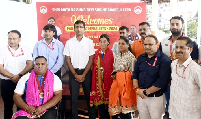 Chief Executive Officer SMVDSB Anshul Garg along with other officers posing with Sheetal Devi and Rakesh Kumar at felicitation ceremony.