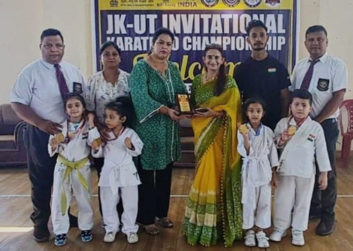 Dignitaries posing along with young Karate players.