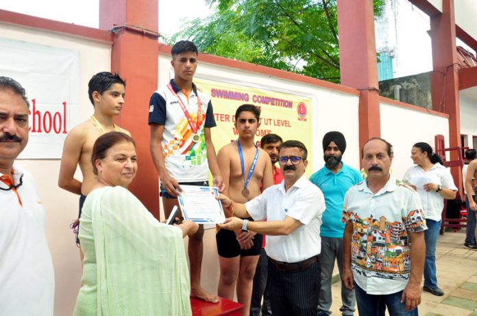 A swimmer receiving certificate during award ceremony in Jammu.