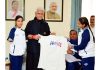 Jersey being presented to Lieutenant Governor Manoj Sinha during meeting with Sheetal Devi and Rakesh Kumar.