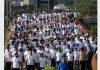 Hundreds of people passing through Bikram Chowk flyover during a walkathon at Jammu on Sunday.