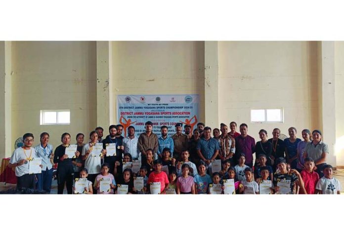 Dignitaries posing along with students during Yogasana Championship at Jammu.