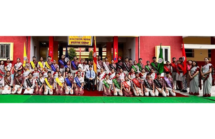 Newly elected students council posing along with school management during a programme in school.