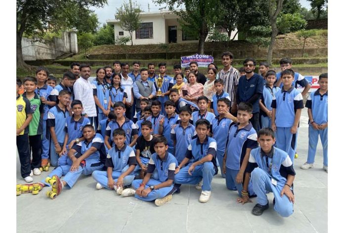 DPS Udhampur team posing along with school management with trophy.