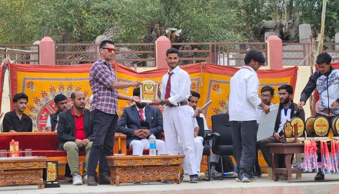 An athlete receiving memento from dignitary at Kargil.   -Excelsior/Basharat Ladakhi