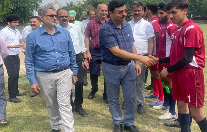 Dignitary interacting with footballers in Jammu.