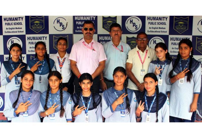 HPS students posing along with medals and school management.