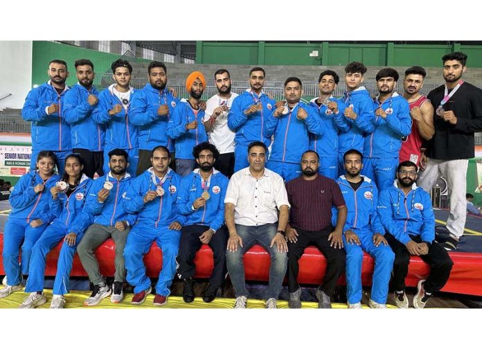 J&K Wushu team posing with medals.