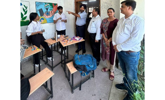 Students making wall painting during a competition at SPMR College of Commerce in Jammu on Monday.