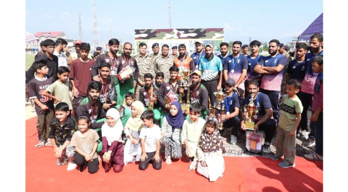 Players posing along with trophy.