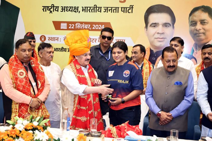 International Rollball player receiving medal from JP Nadda in presence of Dr Jitendra Singh.