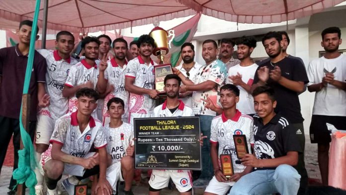 Players of PFC Hiranagar receiving winner's trophy from the chief guest. -Excelsior/Nischant