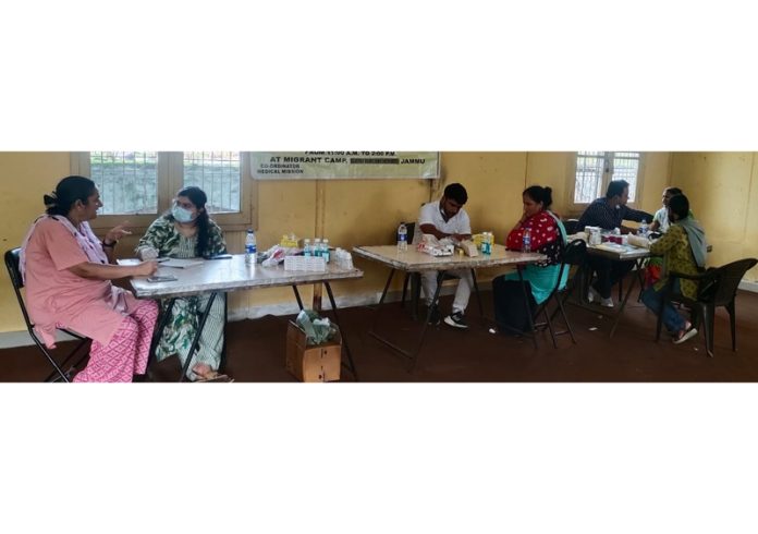 Doctors examining patients during a free dental check up camp at Purkhoo migrant camp on Sunday.