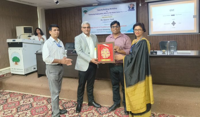 Resource person being presented memento at the capacity building workshop by CUJ.