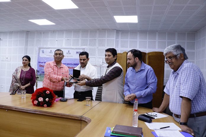 Officials presenting a memento to Om Prakash Bhagat, Director, Skill Development during a function held in Jammu on Thursday.