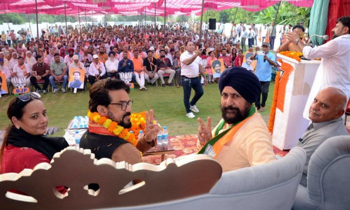 Former Union Minister, Anurag Thakur and BJP national secretary and party candidate from Jammu South, Dr Narinder Singh at a public meeting in Khandwal on Sunday.