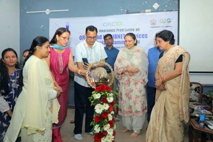 Chief guest lighting ceremonial lamp during inaugural of awareness programme on ORCID & INFLIBNET services.