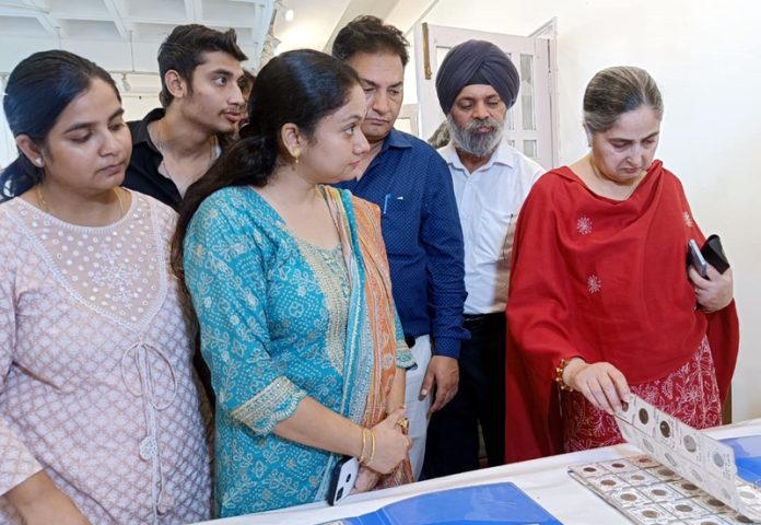 Visitors during three day coins exhibition organised by Kala Kendra Society, Jammu at Master Sansar Chand Gallery on Sunday.