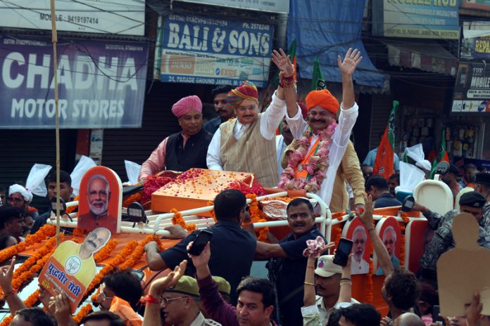 BJP national president and Union Health Minister JP Nadda greeting the public during a road show in Jammu East on Sunday. -Excelsior/Rakesh