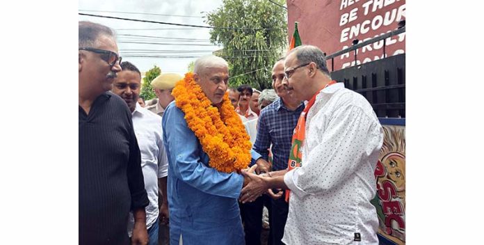 Senior BJP leader Sham Lal Sharma interacting with people in Jammu on Friday.