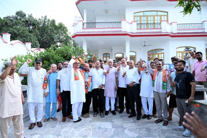 BJP nominee for Jammu North Assembly segment, Sham Lal Sharma with his supporters at Kot Bhalwal, Jammu.