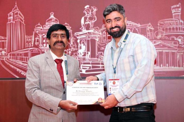 Dr Abhimanyu Rohmetra receiving participation certificate from a dignitary at 58th Indian Orthodontic Conference in Bangalore.