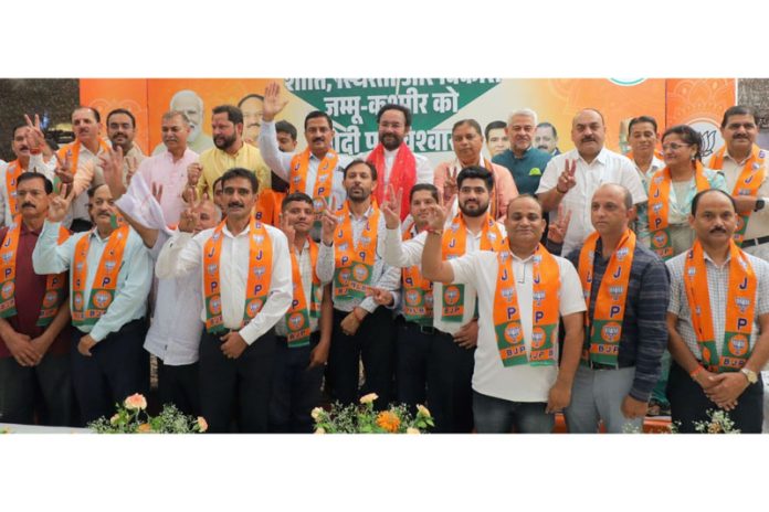 J&K BJP working president, Sat Sharma posing along with others, who joined the party in Jammu on Sunday.